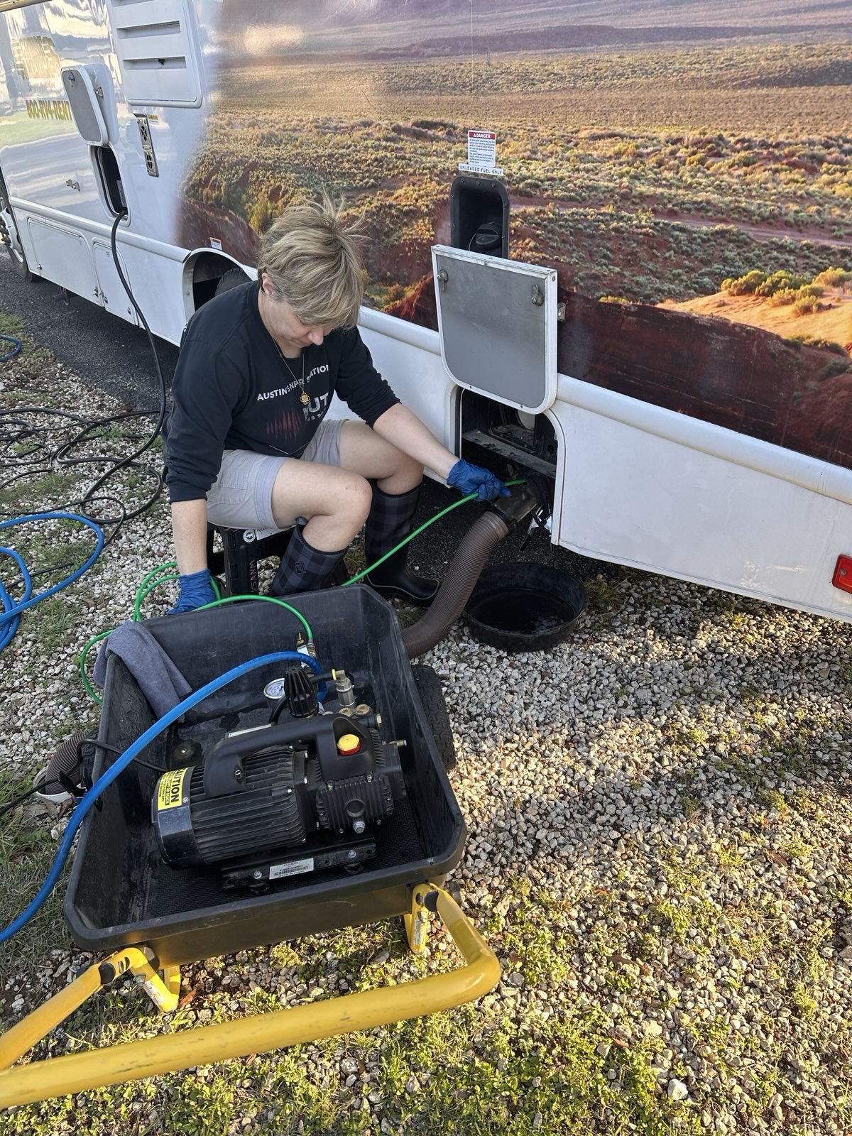 Hydro-jet tank cleaning service in progress on a Class C motorhome