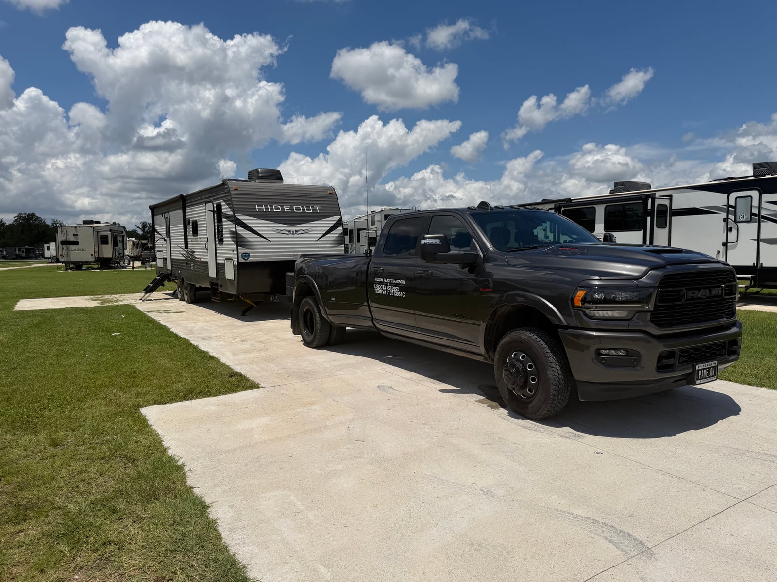 Mission Ready Transport truck parked next to a Hideout travel trailer at an RV park