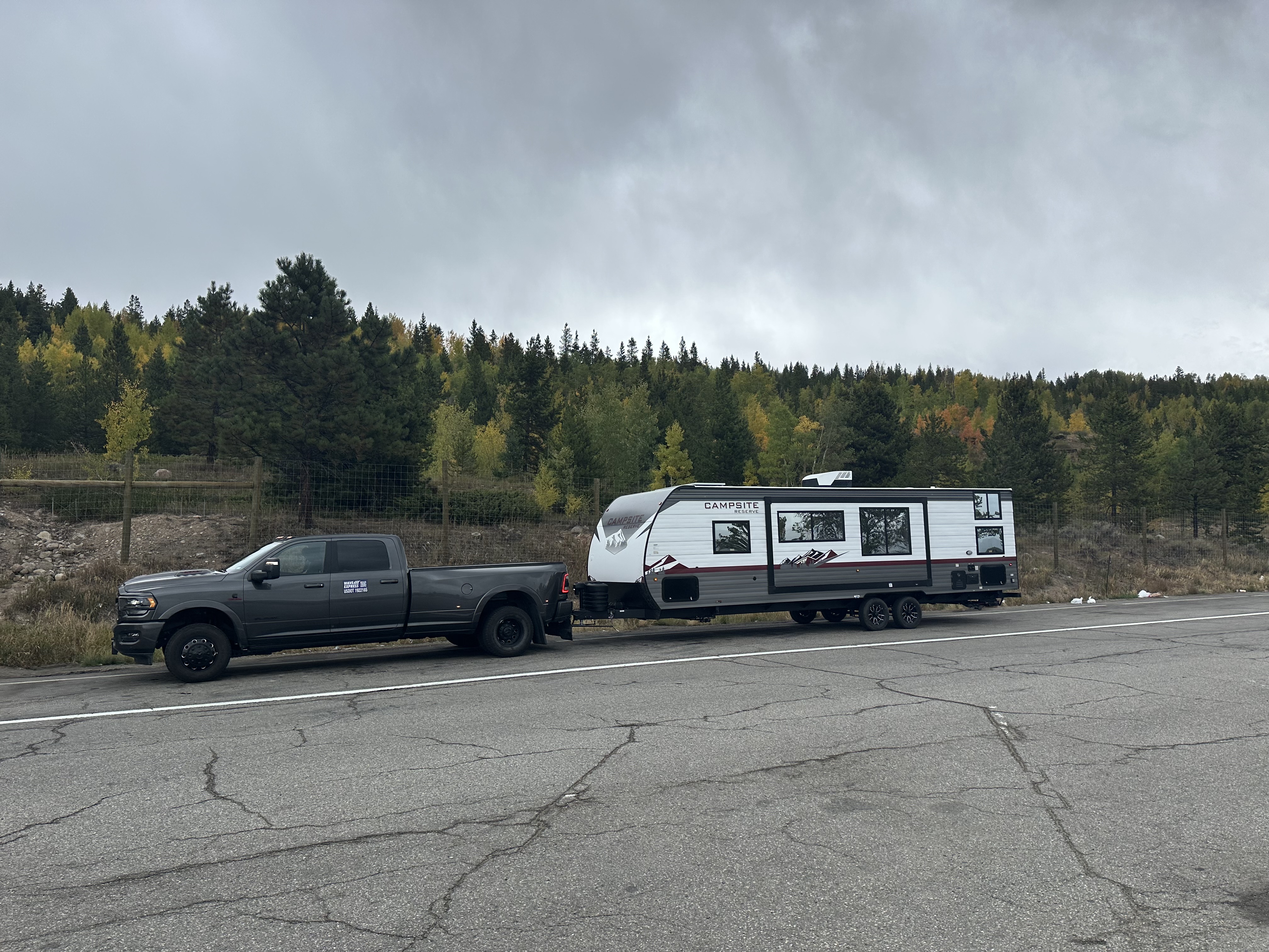 Campsite travel trailer tow through autumn scenery