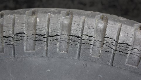Close-up of RV tire dry rot cracking in the tread grooves &mdash; a sign of aged rubber regardless of tread depth